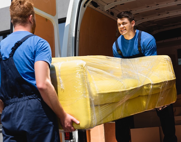 Professional technicians delivering and installing a household appliance