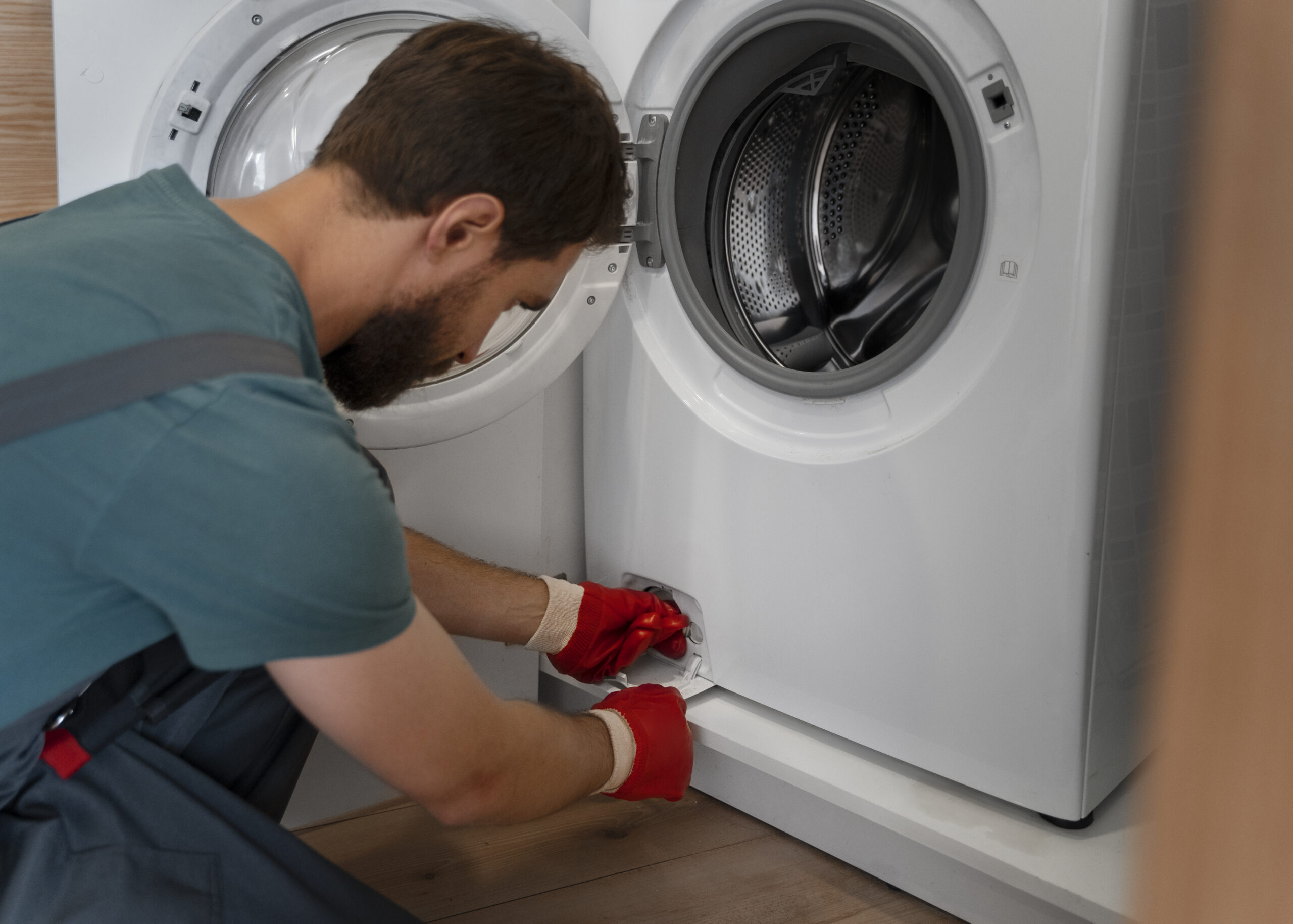 Certified appliance repair technician repairing a front-load washing machine