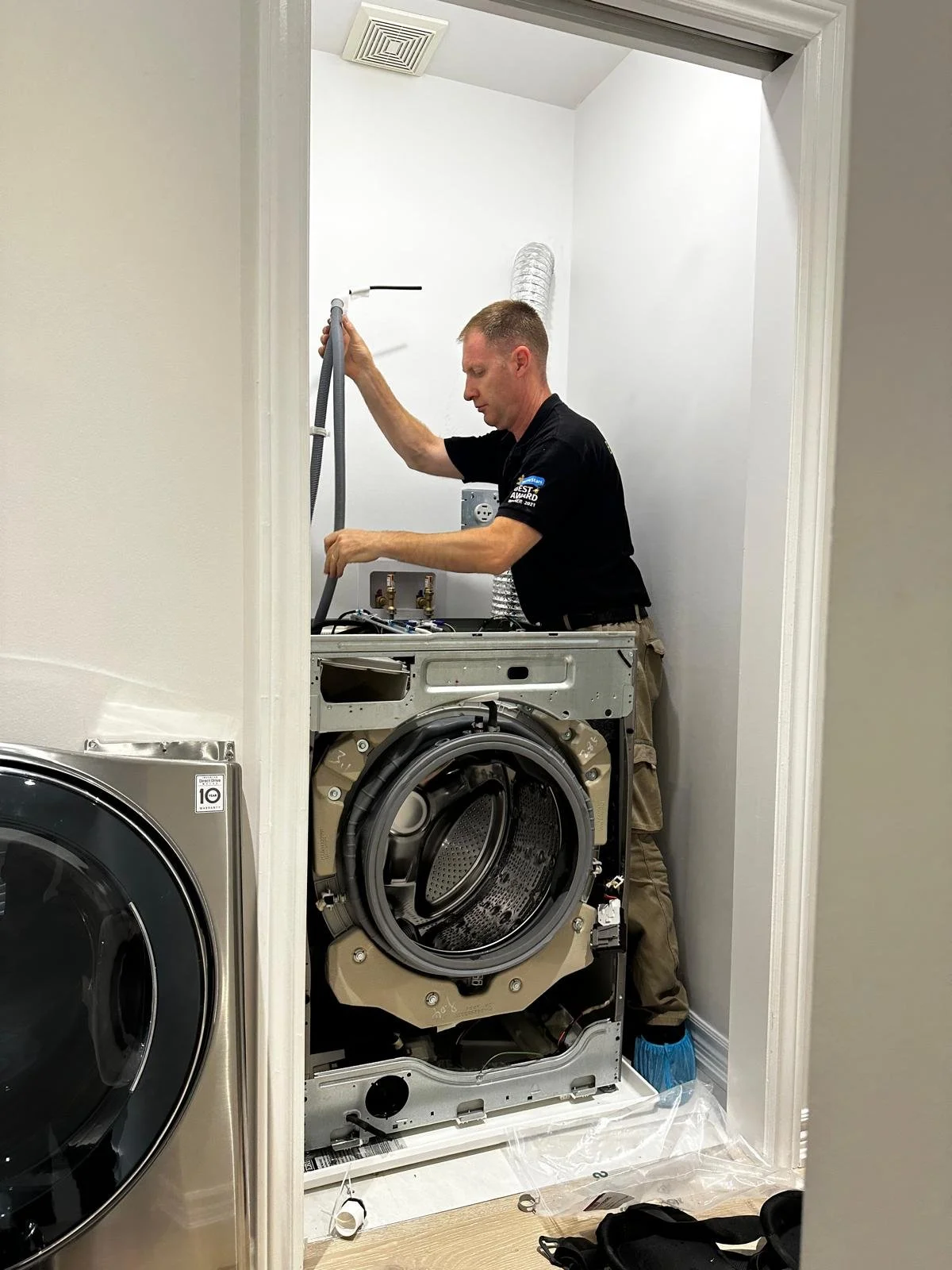 Professional appliance technician replacing heating element safety components
