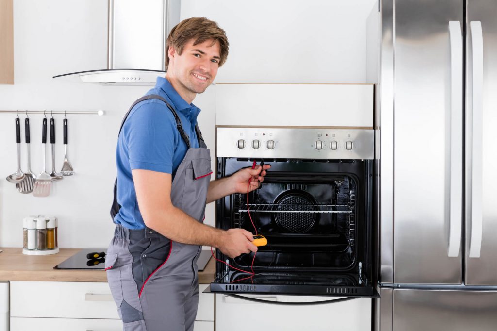Professional appliance repair technician diagnosing a residential oven in Archer, FL 