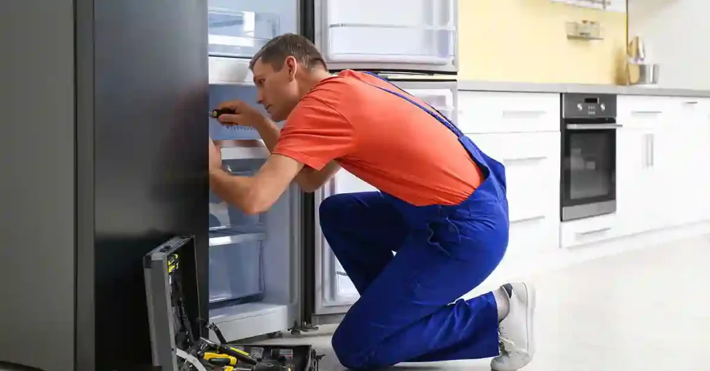 Professional appliance repair technician repairing a residential refrigerator in Hawthorne, FL